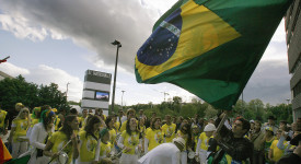 Brazilian football supporters wave the n